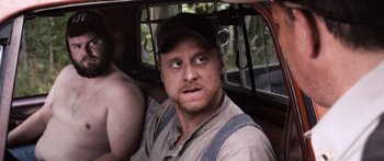 Movie still from “Tucker and Dale vs Evil” (2010), directed by Eli Craig – A person in a car wearing a hat; Close Up shot, Over the shoulder angle
