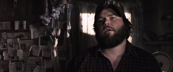 Movie still from “Tucker and Dale vs Evil” (2010), directed by Eli Craig – A man with a beard wearing a hat and a plaid shirt; Close Up shot, Over the shoulder angle