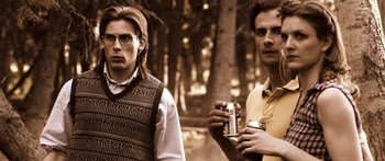 Movie still from “Tucker and Dale vs Evil” (2010), directed by Eli Craig – Two men standing next to each other holding cans of beer; Medium shot, Low angle