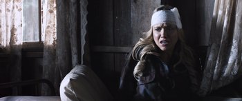 Movie still from “Tucker and Dale vs Evil” (2010), directed by Eli Craig – A woman with a bandage on her head is sitting down; Close Up shot, Over the shoulder angle