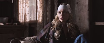 Movie still from “Tucker and Dale vs Evil” (2010), directed by Eli Craig – A woman wearing a headband sitting on a couch; Close Up shot, Over the shoulder angle