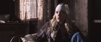 Movie still from “Tucker and Dale vs Evil” (2010), directed by Eli Craig – A woman with long blonde hair wearing a white headband; Close Up shot, Over the shoulder angle