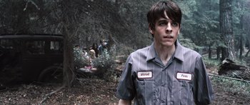 Movie still from “Tucker and Dale vs Evil” (2010), directed by Eli Craig – A young man in a striped shirt is looking at the camera; Close Up shot, Over the shoulder angle