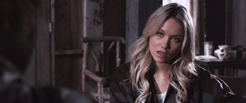 Movie still from “Tucker and Dale vs Evil” (2010), directed by Eli Craig – A woman with long blonde hair sitting in a room; Close Up shot, Over the shoulder angle