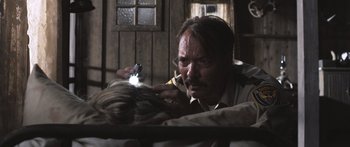 Movie still from “Tucker and Dale vs Evil” (2010), directed by Eli Craig – A man is holding a flashlight while looking at a woman; Close Up shot, Over the shoulder angle
