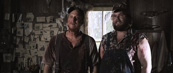 Movie still from “Tucker and Dale vs Evil” (2010), directed by Eli Craig – A couple of men standing next to each other in a room; Medium shot, Low angle