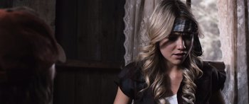 Movie still from “Tucker and Dale vs Evil” (2010), directed by Eli Craig – A woman with long blonde hair sitting in front of a window; Close Up shot, Overhead angle
