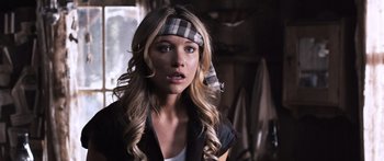Movie still from “Tucker and Dale vs Evil” (2010), directed by Eli Craig – A beautiful young lady with long blonde hair wearing a plaid headband; Close Up shot, Over the shoulder angle