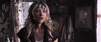 Movie still from “Tucker and Dale vs Evil” (2010), directed by Eli Craig – A woman wearing a plaid head band in a dark room; Close Up shot, Over the shoulder angle