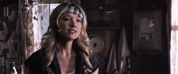 Movie still from “Tucker and Dale vs Evil” (2010), directed by Eli Craig – A beautiful blonde woman wearing a plaid headband; Close Up shot, Over the shoulder angle