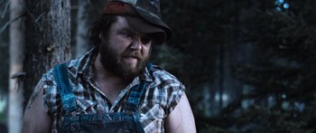 Movie still from “Tucker and Dale vs Evil” (2010), directed by Eli Craig – A person with a beard wearing a hat; Close Up shot, Over the shoulder angle