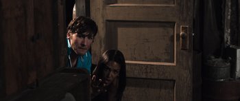 Movie still from “Tucker and Dale vs Evil” (2010), directed by Eli Craig – A man and a woman looking at something in the distance; Medium shot, Over the shoulder angle
