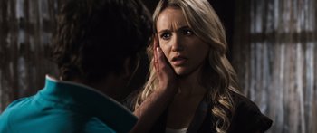 Movie still from “Tucker and Dale vs Evil” (2010), directed by Eli Craig – A woman holding her hand up to her ear; Close Up shot, Over the shoulder angle