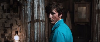Movie still from “Tucker and Dale vs Evil” (2010), directed by Eli Craig – A person wearing a blue jacket; Close Up shot, Low angle