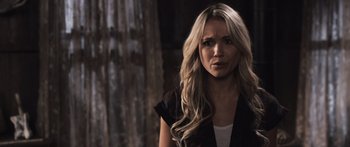 Movie still from “Tucker and Dale vs Evil” (2010), directed by Eli Craig – A woman with long blonde hair standing in front of a window; Close Up shot, Over the shoulder angle