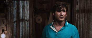 Movie still from “Tucker and Dale vs Evil” (2010), directed by Eli Craig – A man wearing a blue shirt and a white collar; Close Up shot, Over the shoulder angle