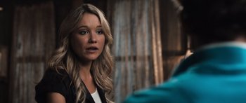 Movie still from “Tucker and Dale vs Evil” (2010), directed by Eli Craig – A woman with long blonde hair is looking into the distance; Close Up shot, Over the shoulder angle