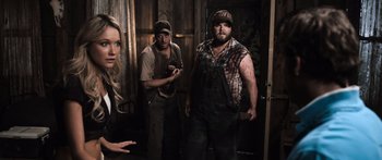 Movie still from “Tucker and Dale vs Evil” (2010), directed by Eli Craig – A group of people standing in front of a door; Medium shot, Over the shoulder angle