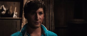 Movie still from “Tucker and Dale vs Evil” (2010), directed by Eli Craig – A young man with a blue shirt is posing for a picture; Close Up shot, Over the shoulder angle