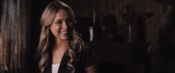 Movie still from “Tucker and Dale vs Evil” (2010), directed by Eli Craig – A beautiful blonde haired woman smiling for the camera; Close Up shot, Over the shoulder angle