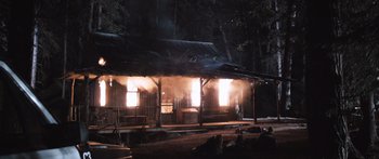 Movie still from “Tucker and Dale vs Evil” (2010), directed by Eli Craig – A building with smoke coming out of the windows at night; Extreme Wide shot, High angle