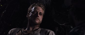 Movie still from “Tucker and Dale vs Evil” (2010), directed by Eli Craig – A person in a dark cave; Close Up shot, Low angle