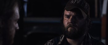 Movie still from “Tucker and Dale vs Evil” (2010), directed by Eli Craig – A man with a beard wearing a baseball cap; Close Up shot, Over the shoulder angle
