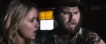 Movie still from “Tucker and Dale vs Evil” (2010), directed by Eli Craig – A man and a woman are looking at each other; Close Up shot, Over the shoulder angle