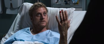 Movie still from “Tucker and Dale vs Evil” (2010), directed by Eli Craig – A man laying in a hospital bed holding his hand up; Close Up shot, High angle
