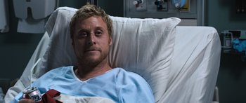 Movie still from “Tucker and Dale vs Evil” (2010), directed by Eli Craig – A man laying in a hospital bed wearing a hospital gown; Close Up shot, High angle