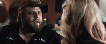 Movie still from “Tucker and Dale vs Evil” (2010), directed by Eli Craig – A man with a beard talking to a woman in a hat; Close Up shot, Over the shoulder angle
