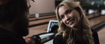 Movie still from “Tucker and Dale vs Evil” (2010), directed by Eli Craig – A woman smiles while holding a hair dryer; Close Up shot, Over the shoulder angle