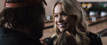 Movie still from “Tucker and Dale vs Evil” (2010), directed by Eli Craig – A woman smiling at a man with a hat on; Close Up shot, Over the shoulder angle