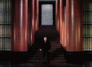 Movie still from “Heaven Can Wait” (1943), directed by Ernst Lubitsch – An older man in a black suit standing in front of a staircase; Wide shot, Low angle