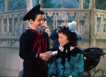 Movie still from “Heaven Can Wait” (1943), directed by Ernst Lubitsch – A boy and a girl dressed up in costumes; Medium shot, High angle