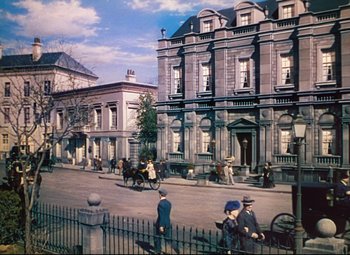 Movie still from “Heaven Can Wait” (1943), directed by Ernst Lubitsch – A painting of people walking down a street; Extreme Wide shot, High angle