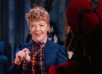 Movie still from “Heaven Can Wait” (1943), directed by Ernst Lubitsch – An older woman wearing a blue dress and a red hat; Close Up shot, Over the shoulder angle