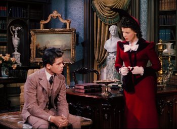 Movie still from “Heaven Can Wait” (1943), directed by Ernst Lubitsch – A man and a woman dressed in formal wear; Medium shot, High angle