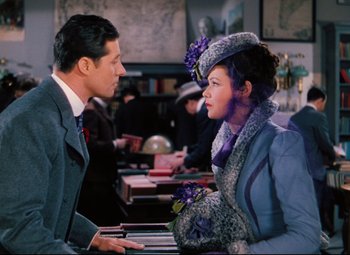 Movie still from “Heaven Can Wait” (1943), directed by Ernst Lubitsch – A man and a woman talking to each other in a room; Medium shot, Over the shoulder angle