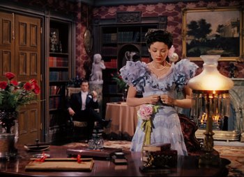 Movie still from “Heaven Can Wait” (1943), directed by Ernst Lubitsch – A man and a woman sitting at a table; Wide shot, High angle