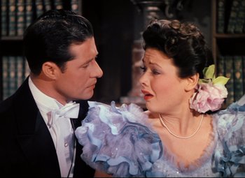 Movie still from “Heaven Can Wait” (1943), directed by Ernst Lubitsch – A man and a woman in formal wear looking at one another; Close Up shot, High angle
