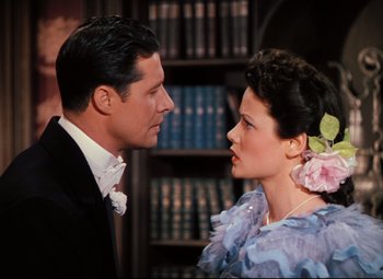 Movie still from “Heaven Can Wait” (1943), directed by Ernst Lubitsch – A man and a woman in formal wear standing next to each other; Medium shot, High angle