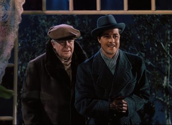 Movie still from “Heaven Can Wait” (1943), directed by Ernst Lubitsch – A couple of men standing next to each other; Medium shot, Over the shoulder angle