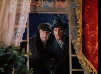Movie still from “Heaven Can Wait” (1943), directed by Ernst Lubitsch – Two men standing next to each other in front of a window; Medium shot, Low angle