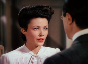 Movie still from “Heaven Can Wait” (1943), directed by Ernst Lubitsch – A woman in a white blouse and a man in a suit; Close Up shot, Over the shoulder angle