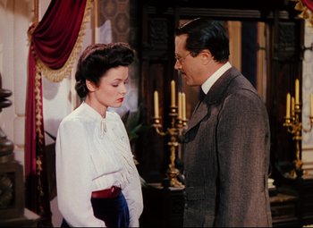 Movie still from “Heaven Can Wait” (1943), directed by Ernst Lubitsch – A man and a woman standing next to each other in a room; Medium shot, High angle
