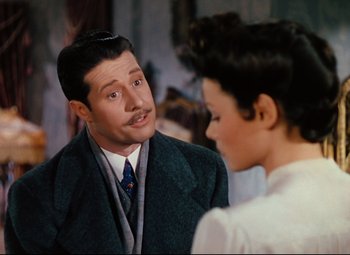 Movie still from “Heaven Can Wait” (1943), directed by Ernst Lubitsch – A man and a woman talking to each other; Medium shot, Over the shoulder angle