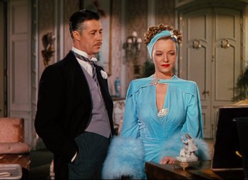 Movie still from “Heaven Can Wait” (1943), directed by Ernst Lubitsch – A man and a woman standing next to each other in a room; Medium shot, Low angle