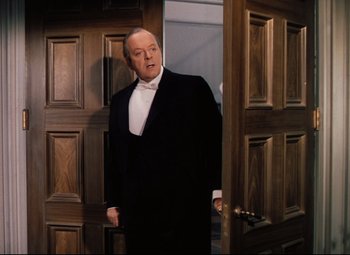 Movie still from “Heaven Can Wait” (1943), directed by Ernst Lubitsch – A man in a tuxedo standing in front of an open door; Medium shot, Over the shoulder angle