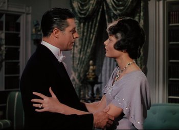 Movie still from “Heaven Can Wait” (1943), directed by Ernst Lubitsch – A man and a woman holding each other in a room; Medium shot, High angle